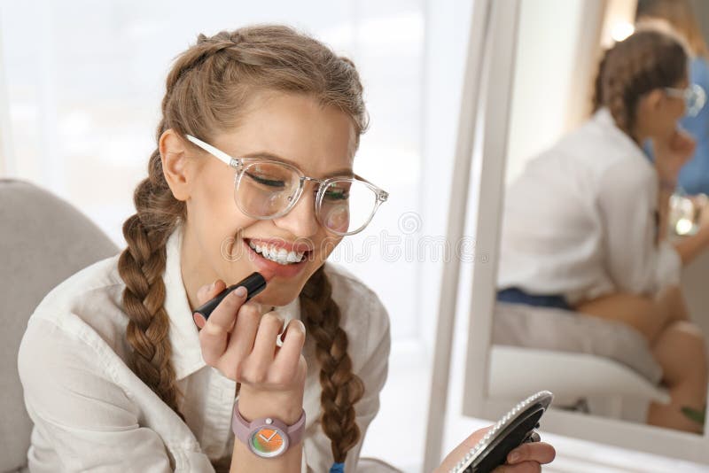 Portrait of beautiful woman applying makeup stock images Portrait of beautiful woman applying makeup stock images