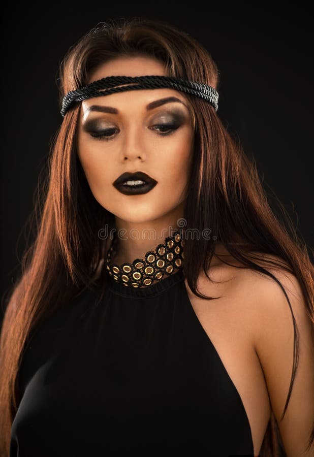 Portrait of beautiful woman in black with wreath and carcanet stock photography Portrait of beautiful woman in black with wreath and carcanet stock photography
