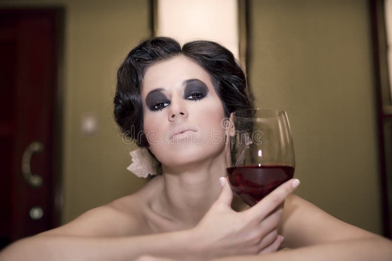 Portrait of beautiful woman with glass red wine