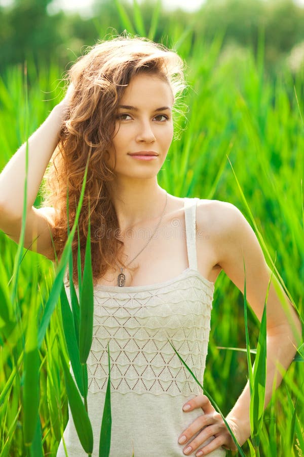 Portrait of Beautiful Woman in Green Grass Stock Photo - Image of light ...