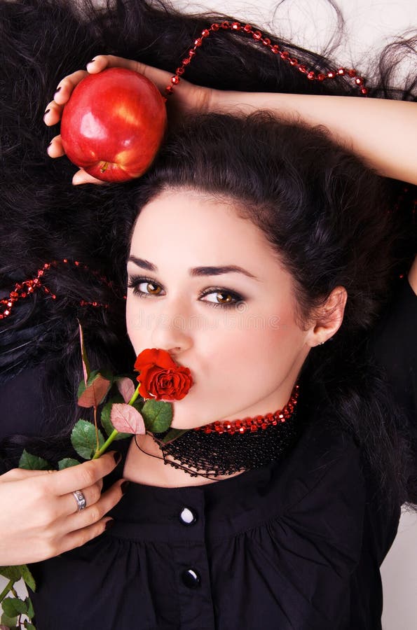 Portrait of a beautiful woman holding a red apple