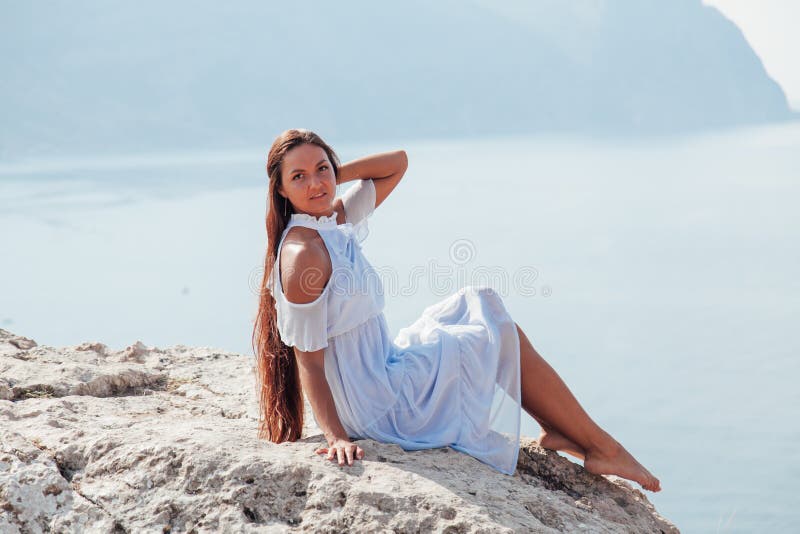 Portrait of a Woman with Long Hair on a Mountain Overlooking the Ocean ...