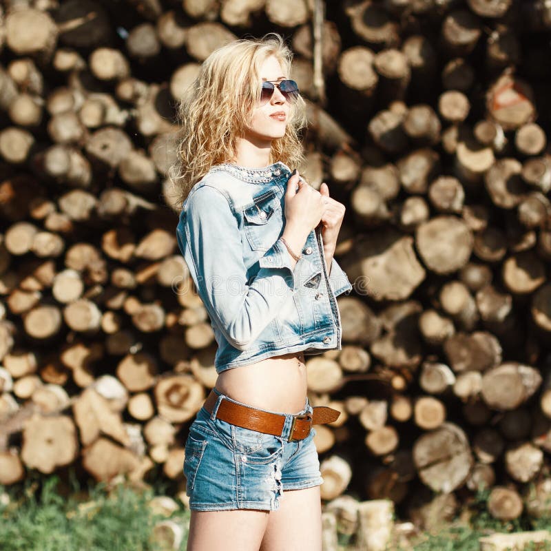 Portrait of a Beautiful Woman in Sunglasses in Denim Shorts and Stock ...