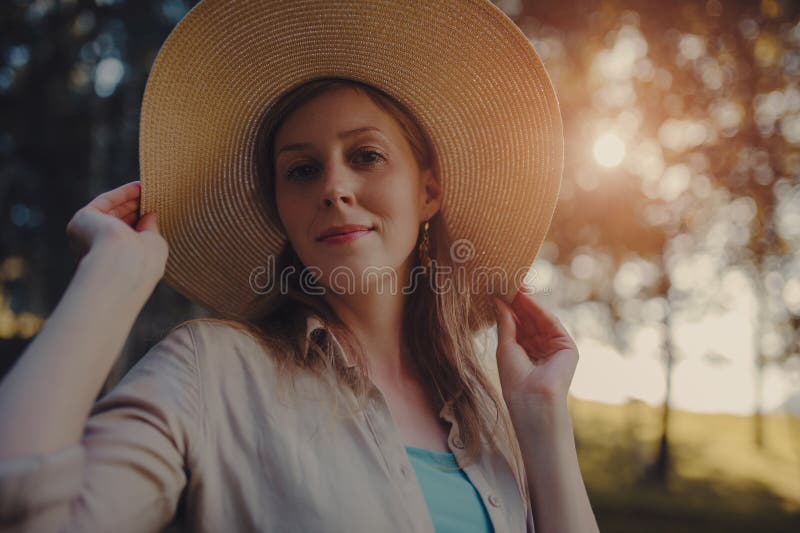 Portrait of beautiful woman wearing hat at sunset light stock images