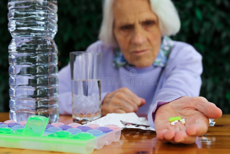 Portrait of beautiful 90 year old woman with pills in hand. Elderly woman, with headache, emotional problem, dementia, mental disorder, frustrated. Elderly concept. Problem wrinkle stock images, royalty-free photos and pictures