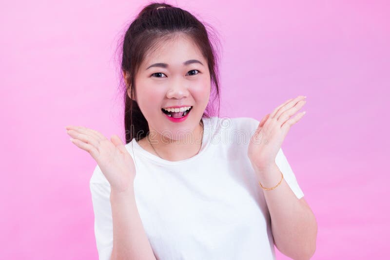 Portrait of beautiful Young Asian woman black hair wear a white t-shirt with open hand. Happy and bright feeling. Cute lovely girl royalty free stock photos Portrait of beautiful Young Asian woman black hair wear a white t-shirt with open hand. Happy and bright feeling. Cute lovely girl royalty free stock photos