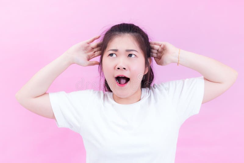 Portrait of beautiful Young Asian woman black hair wear a white t-shirt. with shocked facial expression. Portrait of surprised royalty free stock photo Portrait of beautiful Young Asian woman black hair wear a white t-shirt. with shocked facial expression. Portrait of surprised royalty free stock photo
