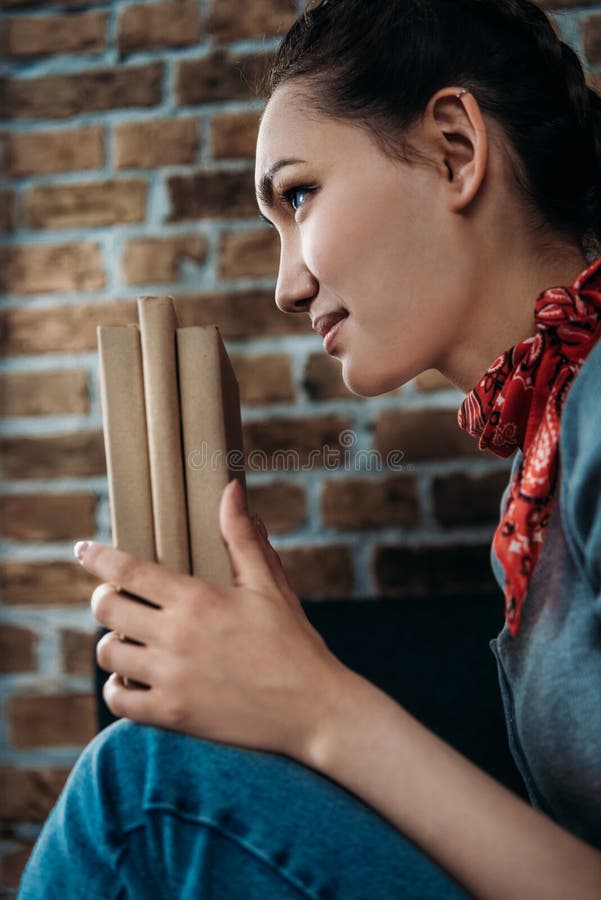 Portrait of beautiful young asian woman holding books and looking away stock photography Portrait of beautiful young asian woman holding books and looking away stock photography