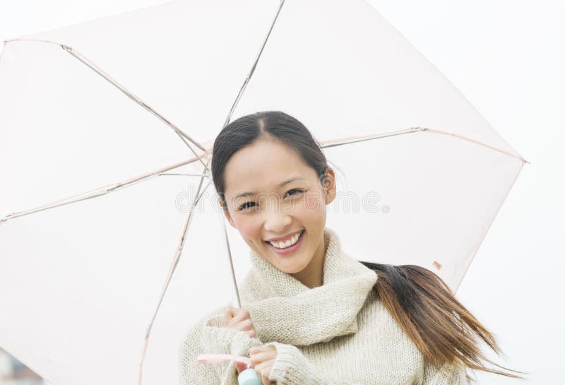 Portrait Of Beautiful Young Asian Woman Holding Umbrella