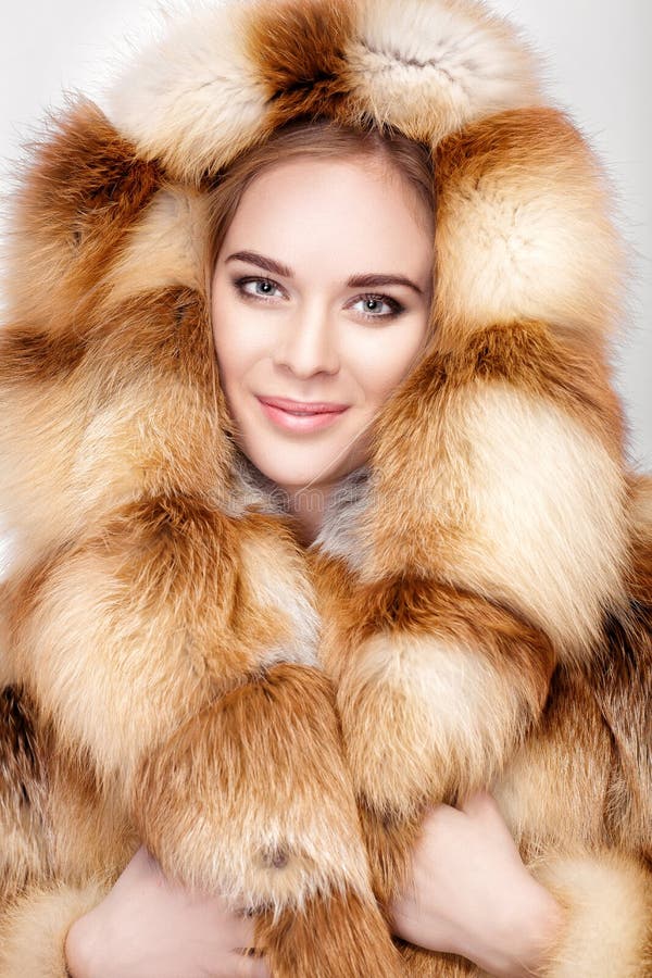 Portrait of Beautiful Young Blonde Woman in Luxury Fox Fur Coat. Stock