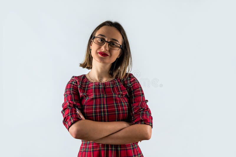 Portrait of a beautiful young brunette holding folded hands isolated on a plain background. royalty free stock images