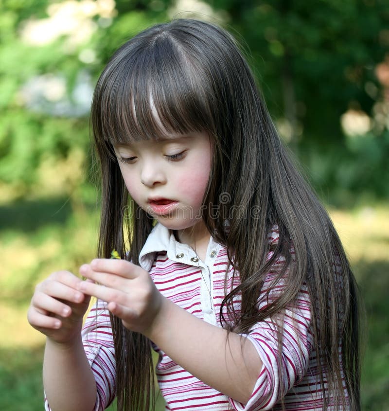 Portrait of beautiful young girl with flower