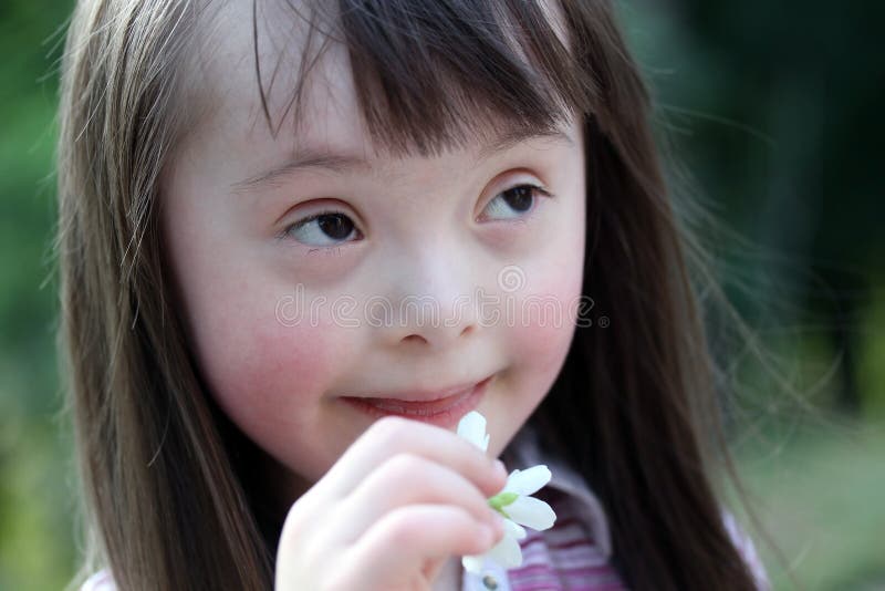 Portrait of beautiful young girl with flowers.