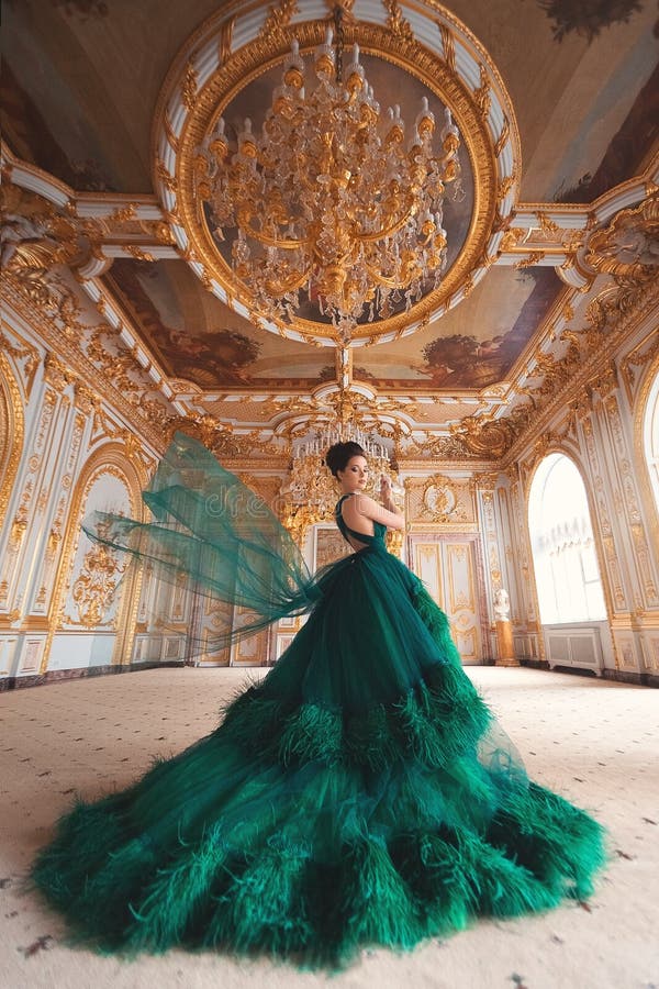 Portrait of a beautiful young girl in a Haute couture green dress