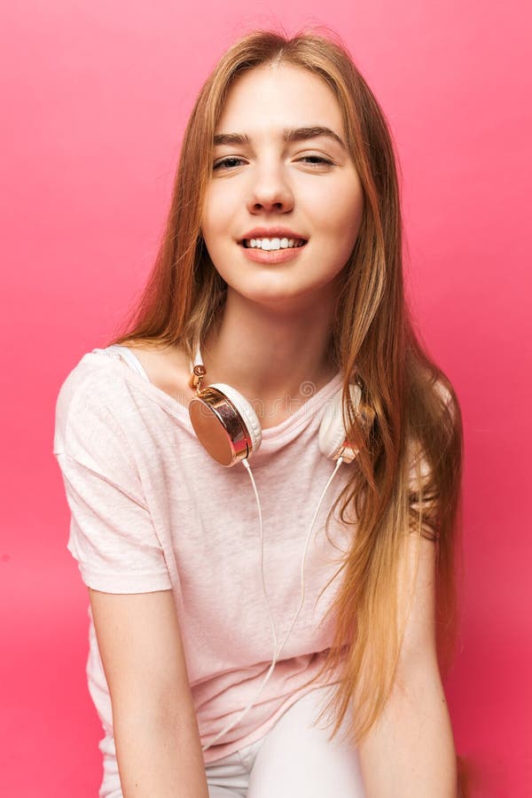Portrait of beautiful young girl standing on pink background wit stock photography Portrait of beautiful young girl standing on pink background wit stock photography