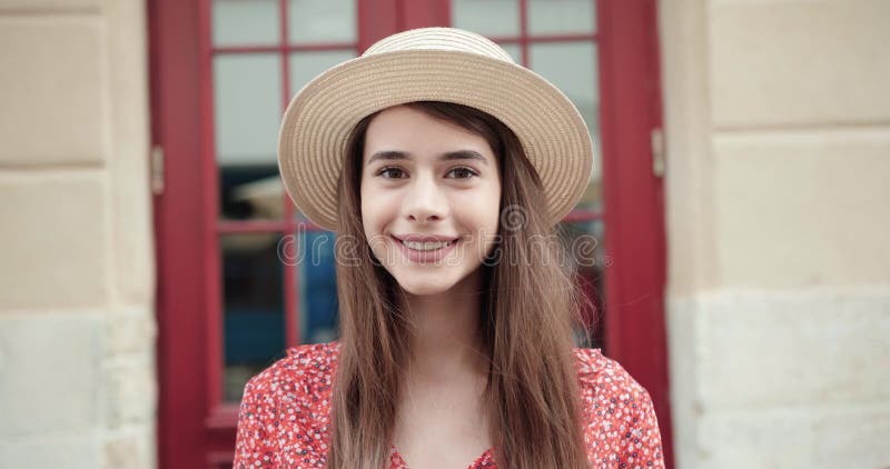 Portrait of a beautiful young lady in a straw hat. Girl in hat.