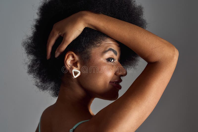 Portrait of beautiful young African American woman in underwear lying  relaxing on white bed at home. Smiling pretty millennial black female in  underclothing garment. Body positive concept. Stock-foto