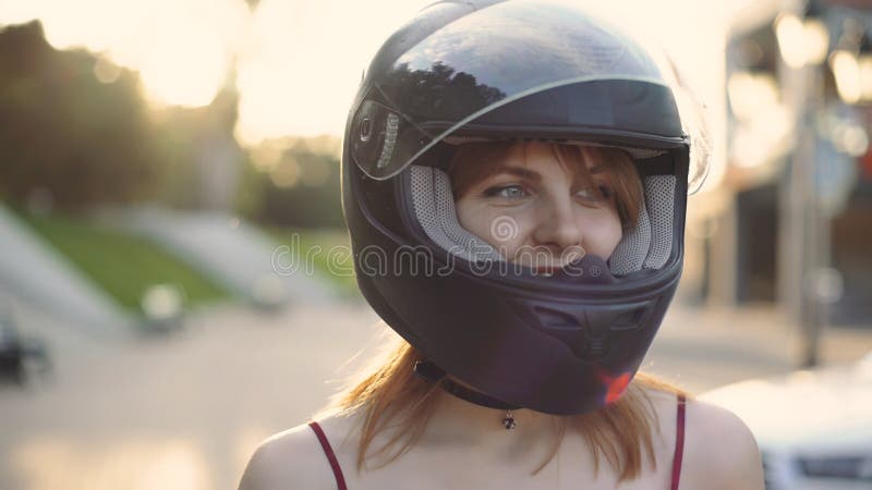 Beautiful Young Red-haired Woman Motorcyclist with Black Motorcycle ...