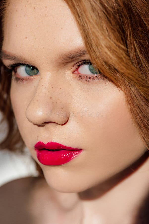 Portrait Of Beautiful Young Redhead Woman With Red Lips Looking At