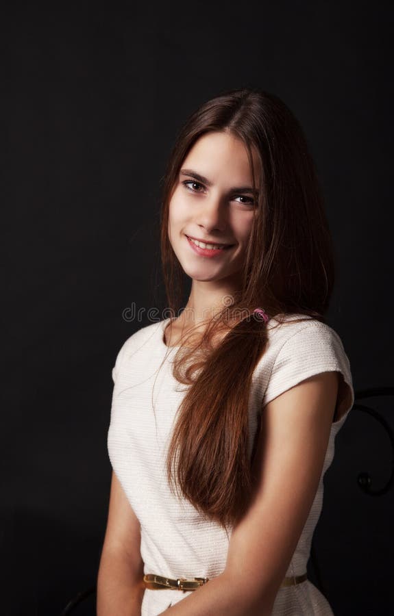 Portrait of a beautiful young smiling girl in a bright dress