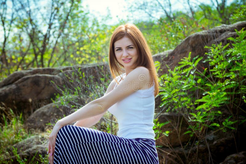 Portrait of beautiful young smiling woman with long red hair