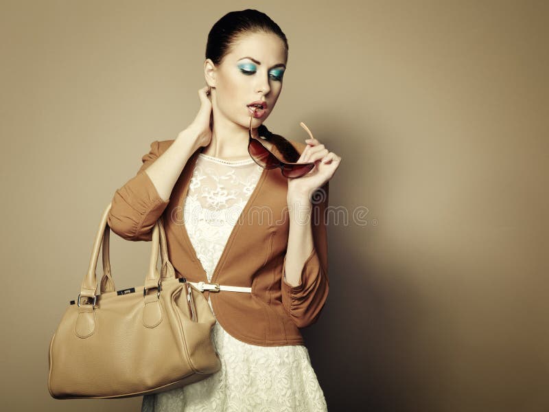 Portrait of beautiful young woman with bag