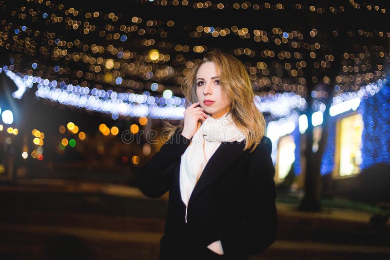 Portrait of Beautiful young woman in black on a background of a night city stock images Portrait of Beautiful young woman in black on a background of a night city stock images