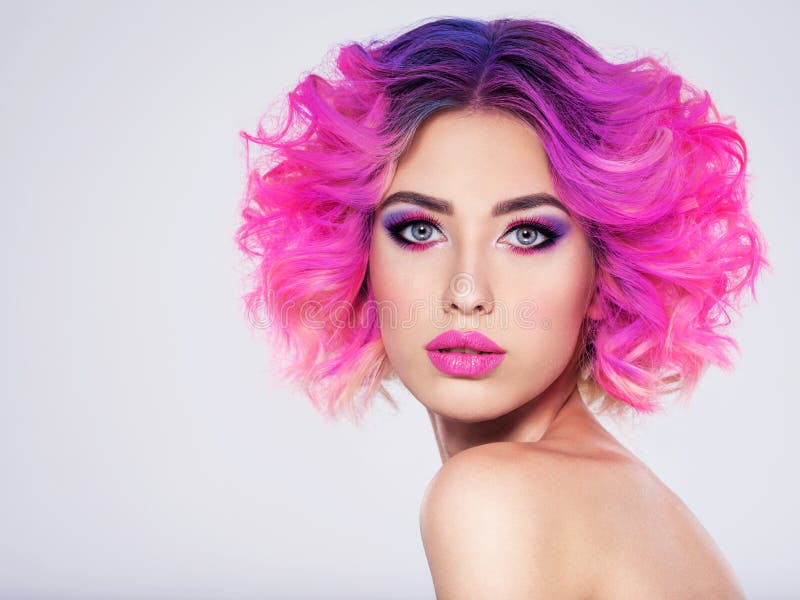 Portrait of beautiful young woman with bright pink makeup. Beautiful blonde with bright pink lipstick on her lips. Pretty girl with vivid hair. Blonde with brightly colored hair. Bright eye makeup
