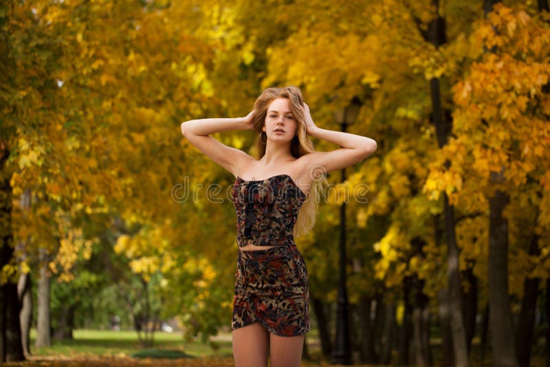 Close up portrait of beautiful young blonde woman in sexy dress, autumn park outdoors. Close up portrait of beautiful young blonde woman in sexy dress, autumn park outdoors