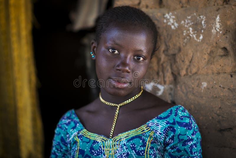 Portrait of of a beautiful young woman, in the village of Mandina Mandinga in the Gabu Region stock photo Portrait of of a beautiful young woman, in the village of Mandina Mandinga in the Gabu Region stock photo