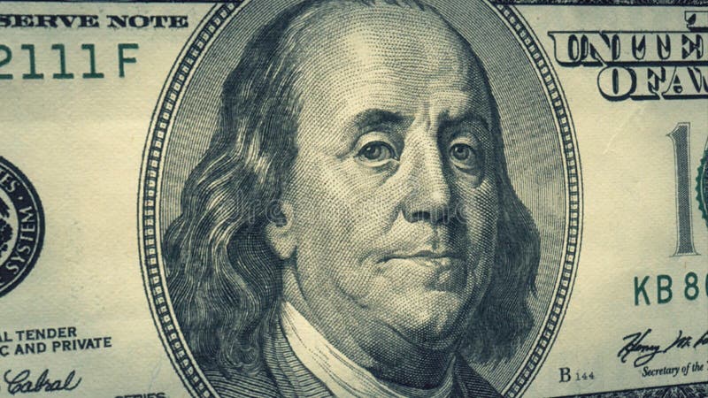 Portrait Benjamin Franklin on USA money One hundred dollars banknote pile