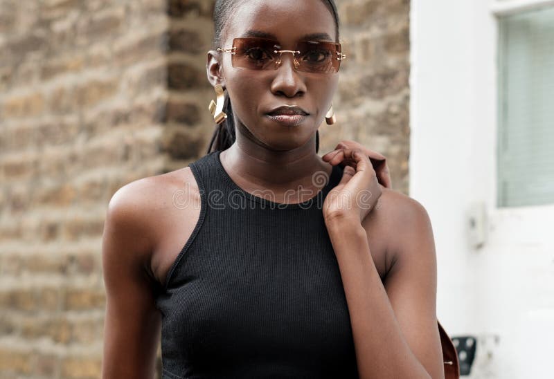 Portrait of Black Female in Fashion Posing with Sunglasses Stock Photo ...