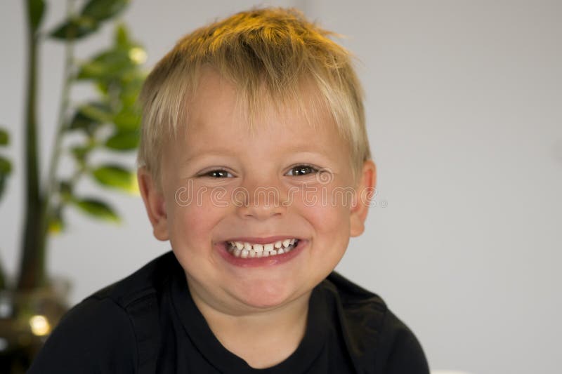 Portrait of blond beautiful 3 or 4 years old caucasian kid smiling happy in joyful face expression at home looking to ca royalty free stock photos Portrait of blond beautiful 3 or 4 years old caucasian kid smiling happy in joyful face expression at home looking to ca royalty free stock photos
