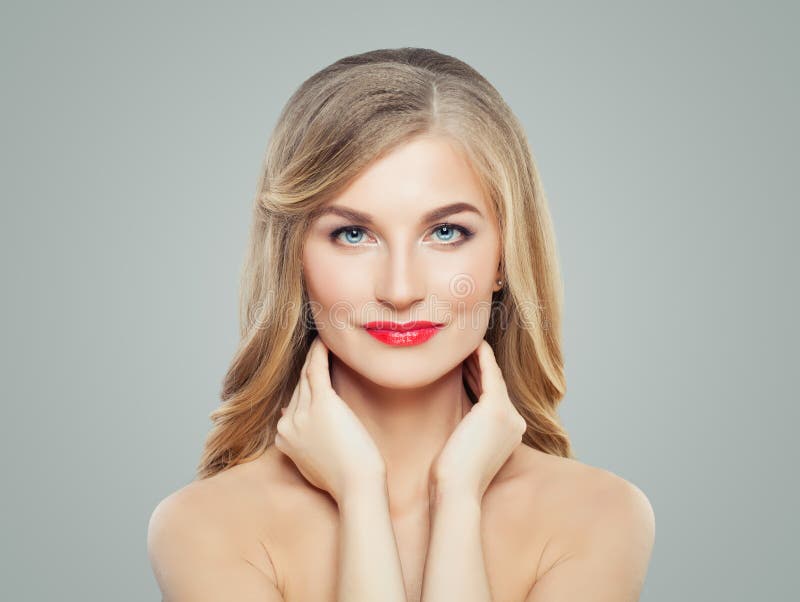 Portrait of blonde woman with healthy hair, clear skin and red lips makeup. Perfect female face.