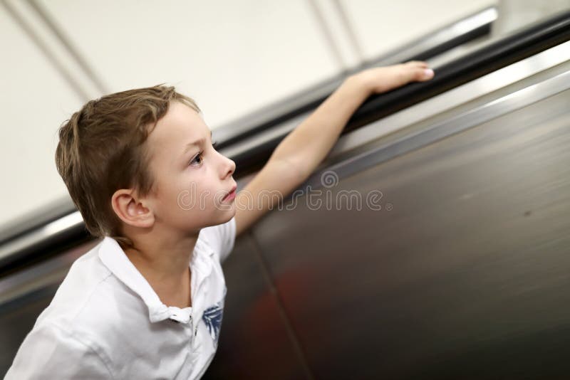 Boy on escalator stock image. Image of looking, active 128277447