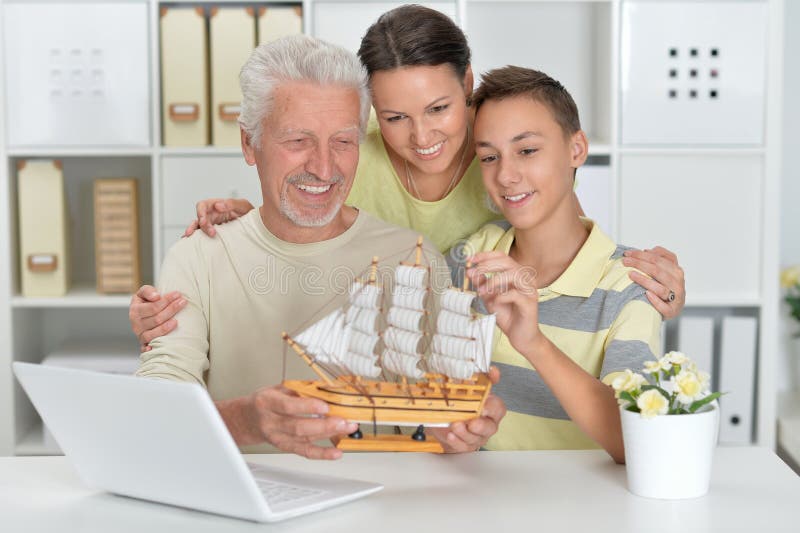 Portrait of boy, mother and grandfather with a laptop and mode stock image Portrait of boy, mother and grandfather with a laptop and mode stock image