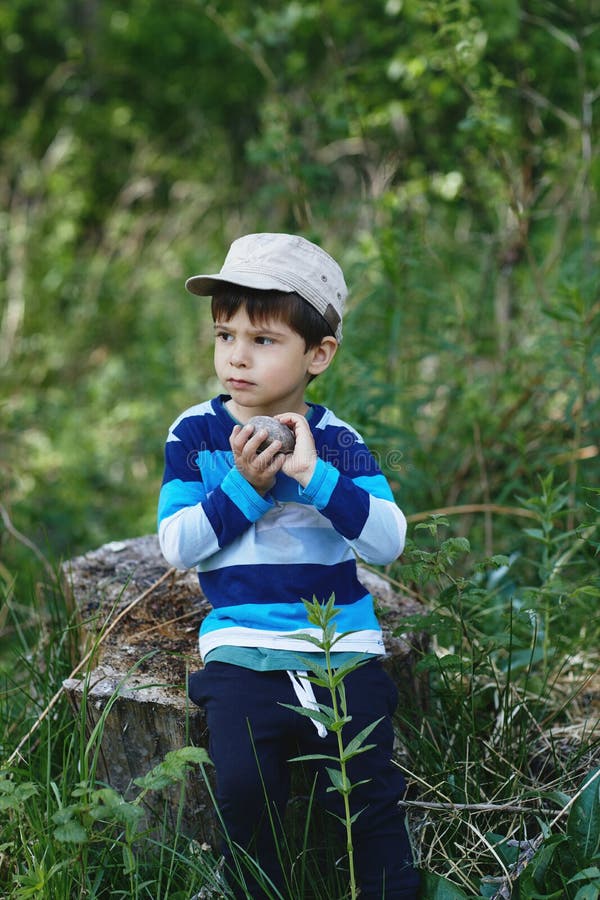 Portrait of a Boy in Nature. Summer Green Background Stock Photo