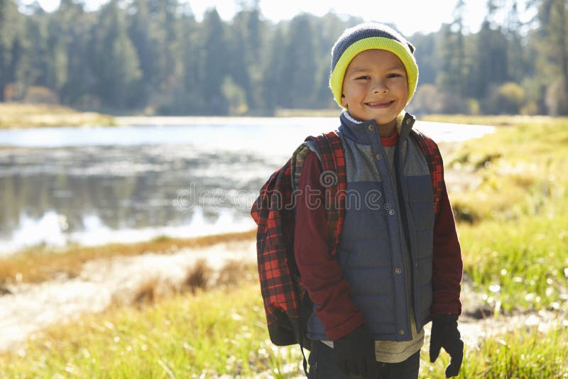Portrait of a boy standing by a lake on a camping trip royalty free stock photos Portrait of a boy standing by a lake on a camping trip royalty free stock photos