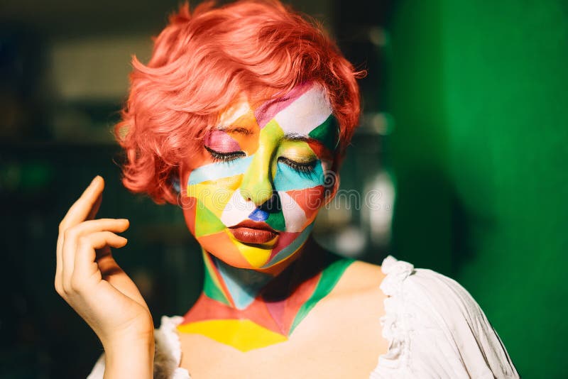 Portrait of a bright woman with orange hair and multi-color makeup stock images Portrait of a bright woman with orange hair and multi-color makeup stock images