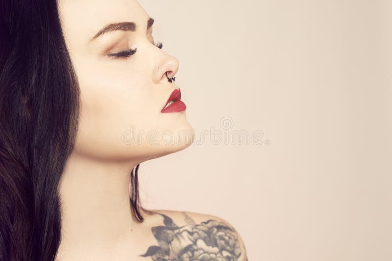 Woman with nose ring stud and tattoo - Stock Image - F011/9928 - Science  Photo Library