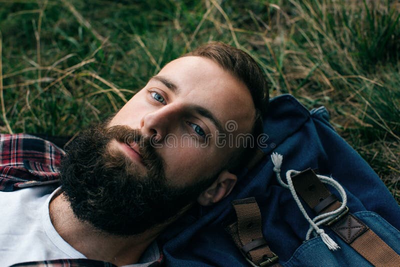 Portrait brutal bearded hipster man in the forest stock photography