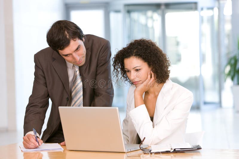 Portrait of business colleagues working on laptop