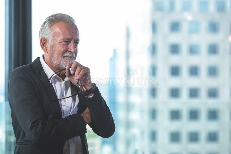 Portrait business partner executive smart man smiling and standing in modern office. Old people businessman thinking him work and