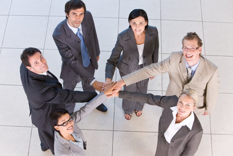 Portrait of business people holding hands royalty free stock photography