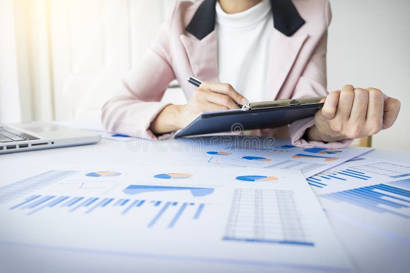 Portrait of business woman with laptop, finance graph and writes