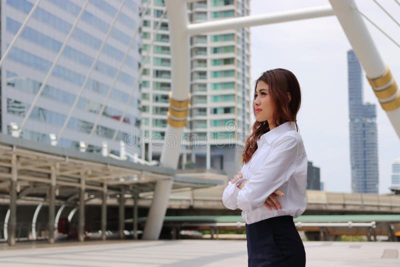 Portrait of business woman leader looking far away at outdoor public