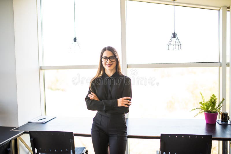 Portrait of business woman standing in modern office stock photos Portrait of business woman standing in modern office stock photos
