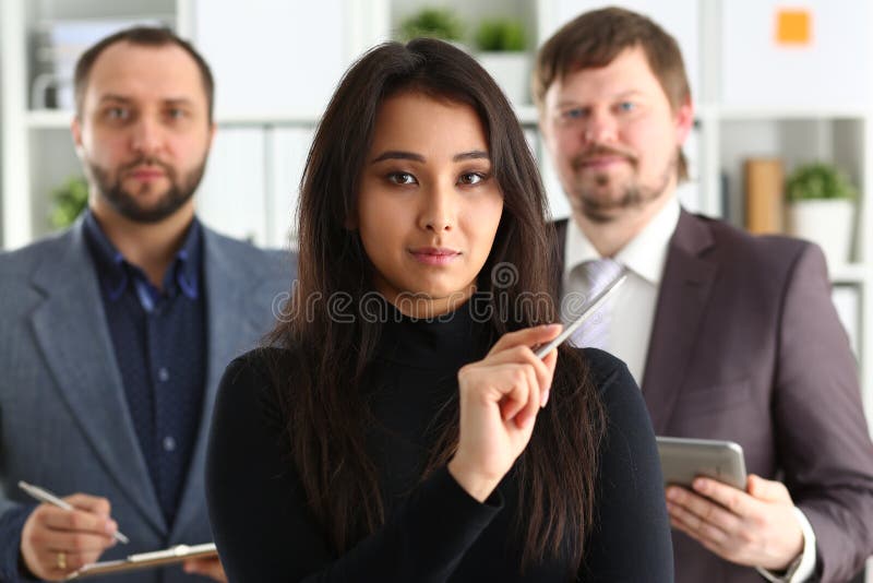 Portrait of businesslady and two businessmen in office royalty free stock images Portrait of businesslady and two businessmen in office royalty free stock images