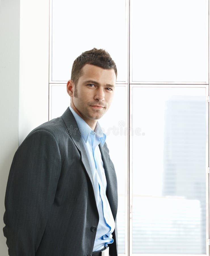 Portrait of businessman at office window