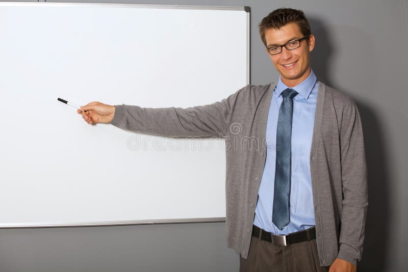 Portrait of Businessman Pointing at Whiteboard in Office Stock Photo